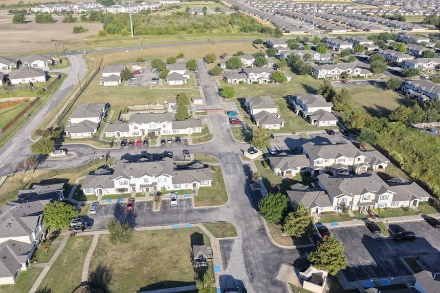 Aerial view of a large Texas apartment complex showcasing multi-family residential roofing systems and community layout.